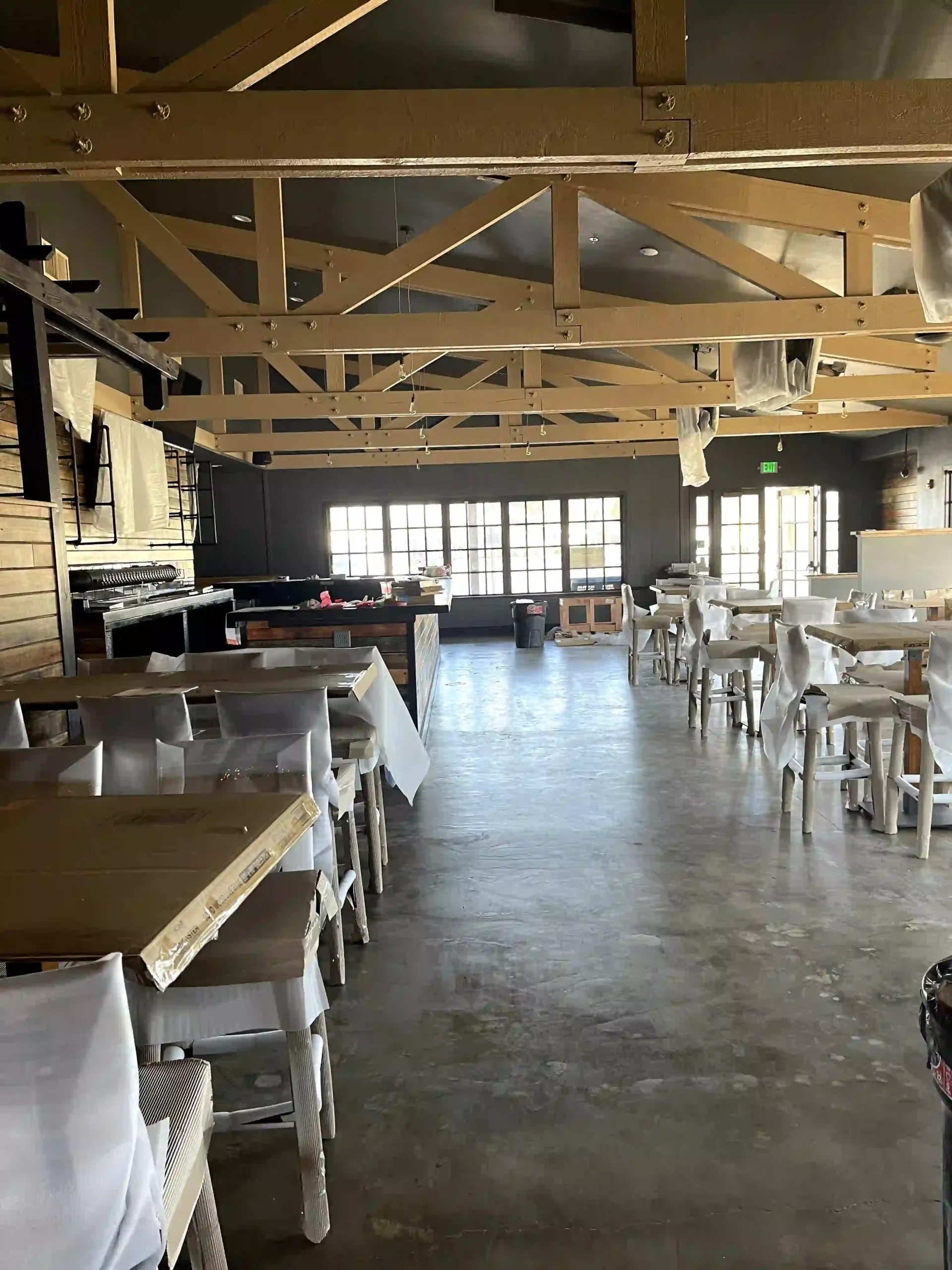 Restaurant build-out in progress with exposed truss ceiling wiring by Beckler Electric