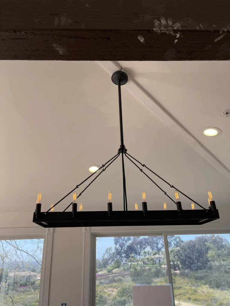 Residential electrical services: a linear chandelier installed on a vaulted ceiling in an Orange County home